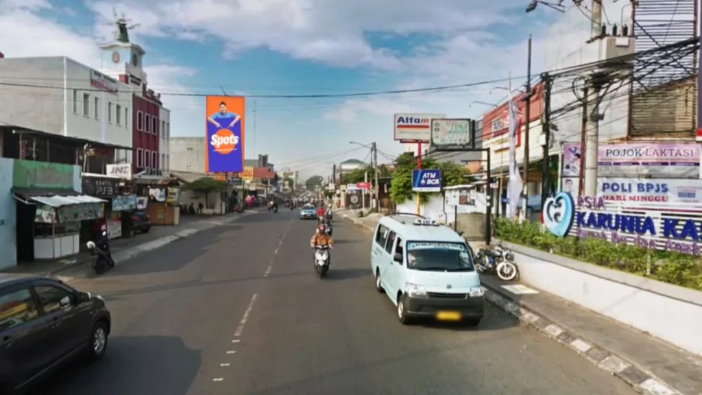 Sewa Billboard Bekasi di Jl. Raya Jatiwaringin depan Holland Bakery, lokasi strategis untuk iklan outdoor.